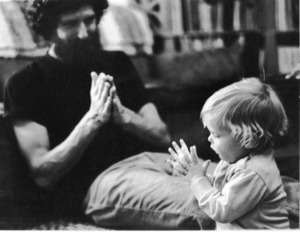 A man plays a game with a young child