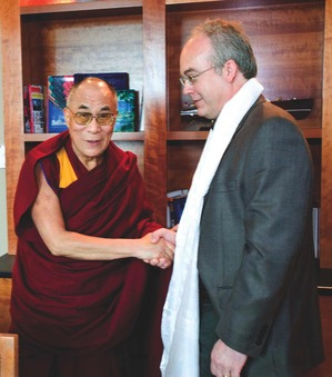Two men shake hands