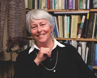 A woman in front of a bookcase