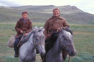 Two men on horseback outdoors