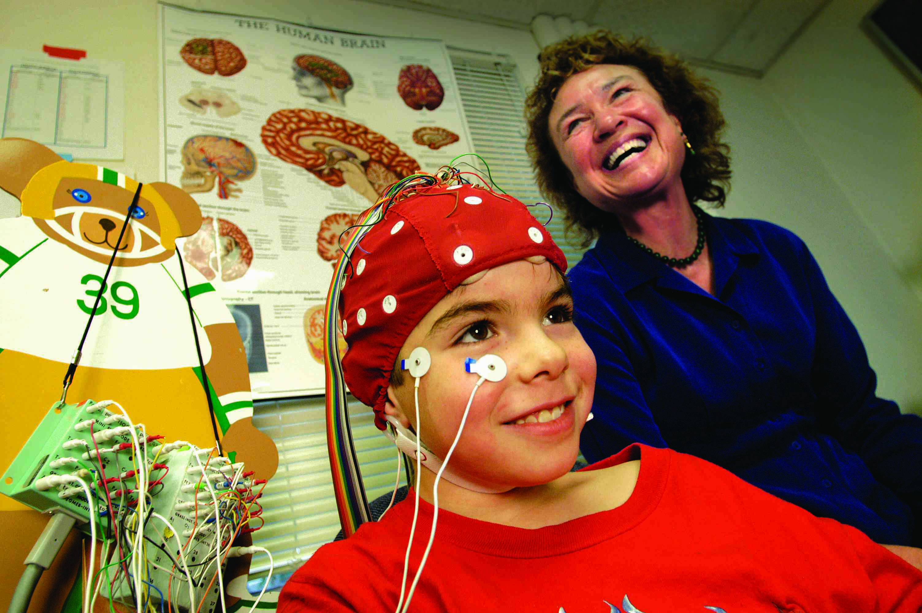 A woman with a young subject in a laboratory