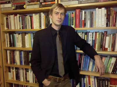 A man in front of a bookcase 