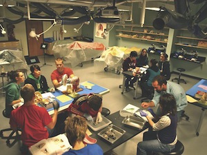 Students sit around tables in a laboratory