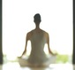 A woman seated in a meditation pose