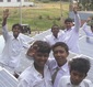 Students celebrate near solar panel grids