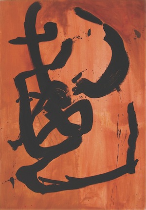 Art with a black painted design over a red background.