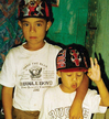 Two young boys wearing matching sports caps