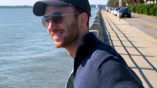 Shane Lofgren stands by the water