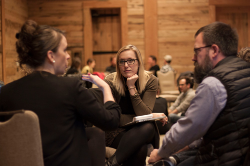 group of three people talking