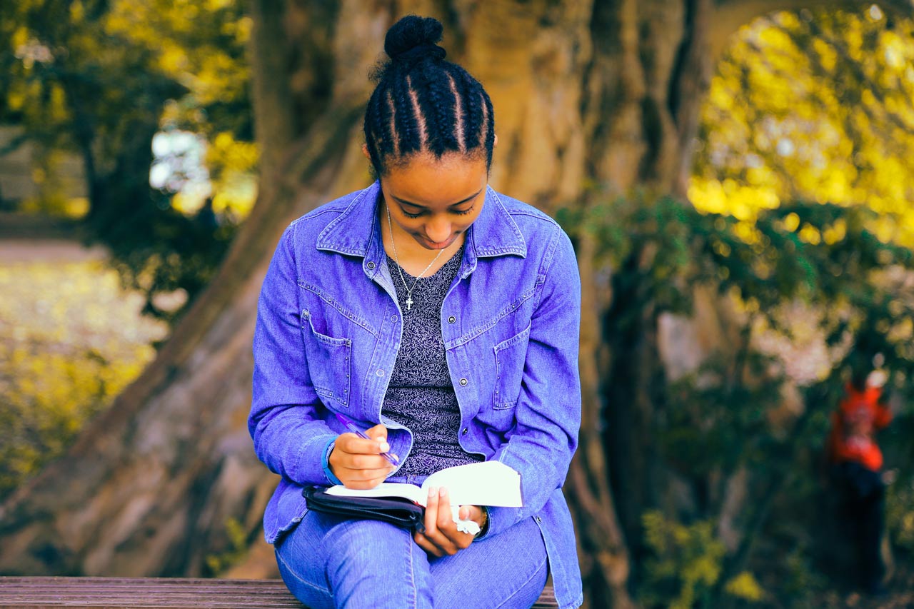 girl journaling outside