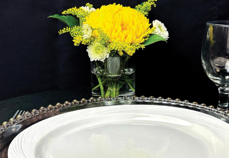 Photo of serving plate and flower and glassware.