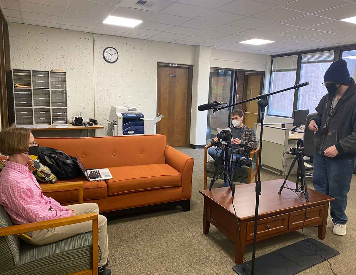 image of entryway of office building, couches and person interviewed