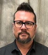 person smiles for a portrait