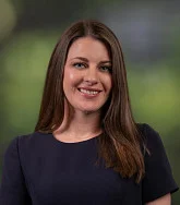 Professional portrait of person with greenery in background