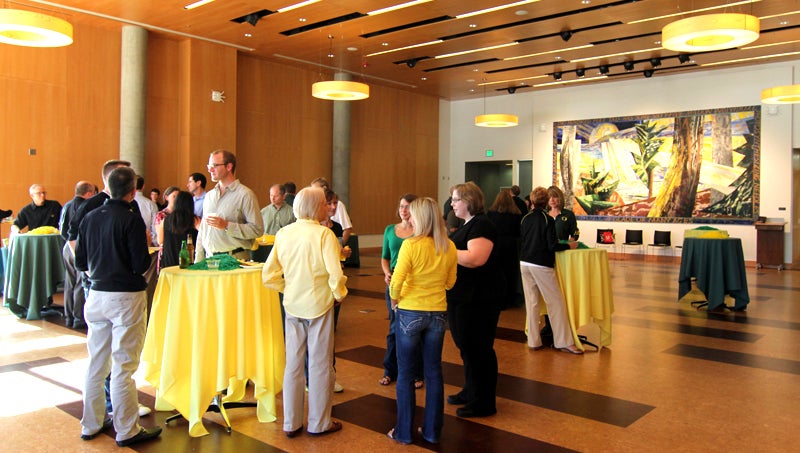 Guests gathered around bar height tables.