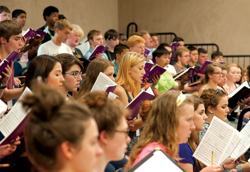 Young adults in choir classroom.