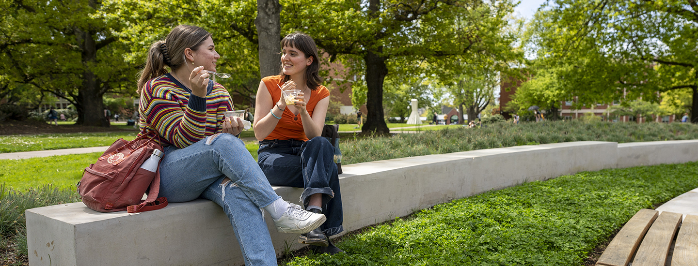 Students sit in the sun and enjoy a frozen treat