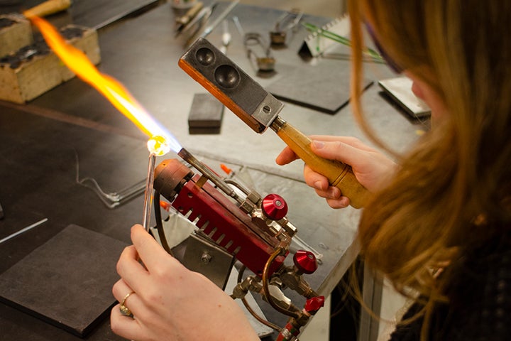 Student using torch on project.