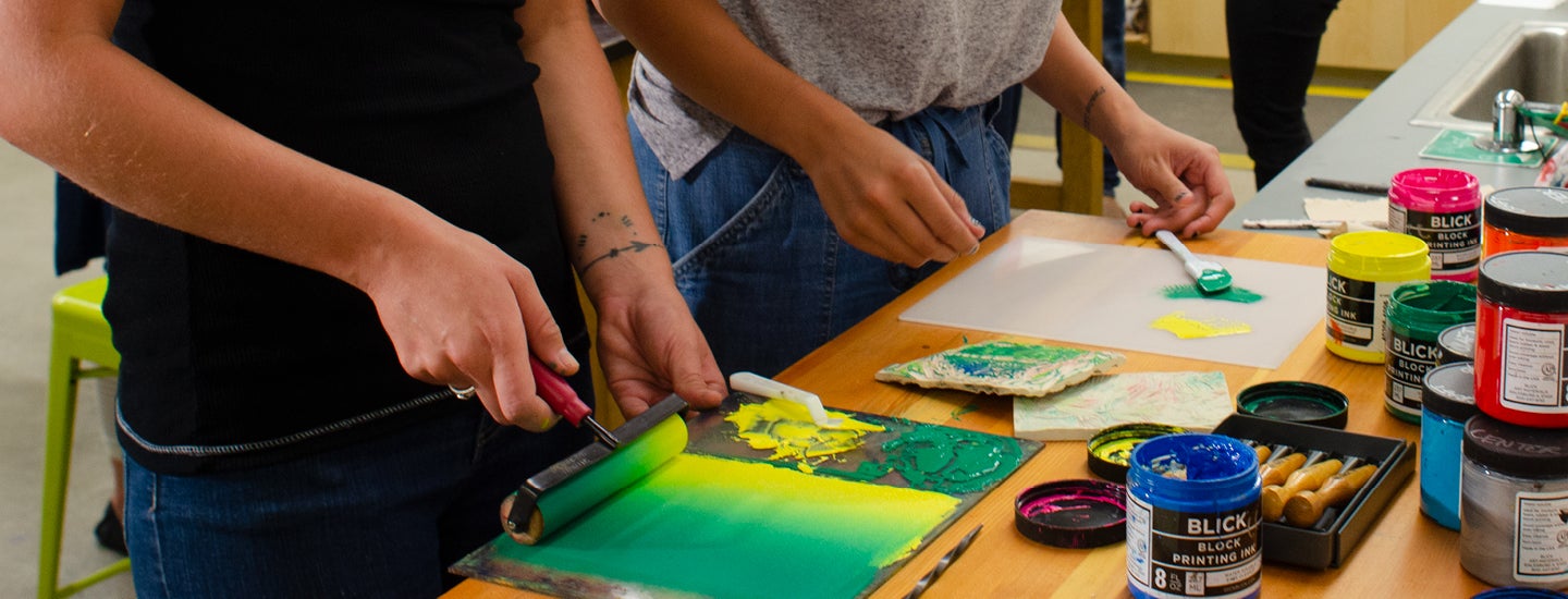 Craft Center members painting onto block for block printing.
