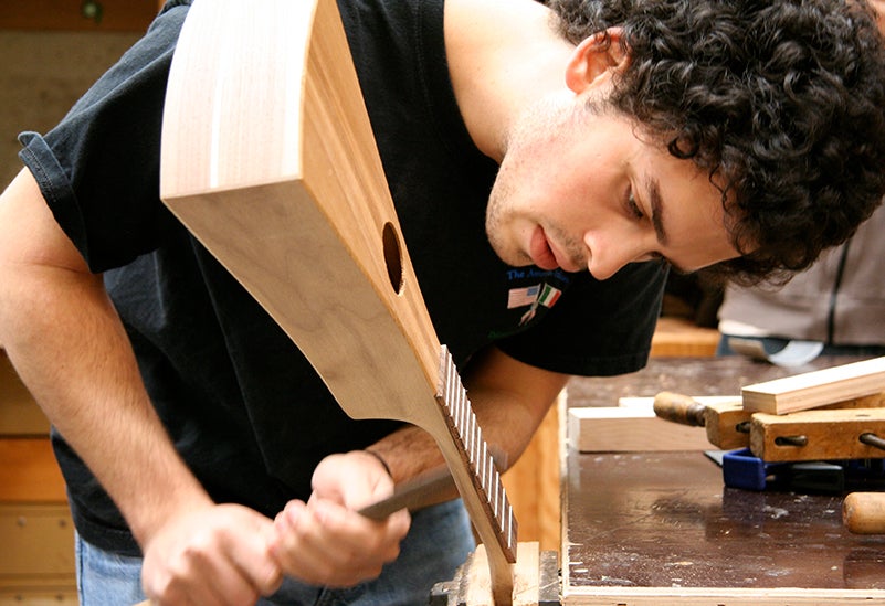 Student using wood working tools.