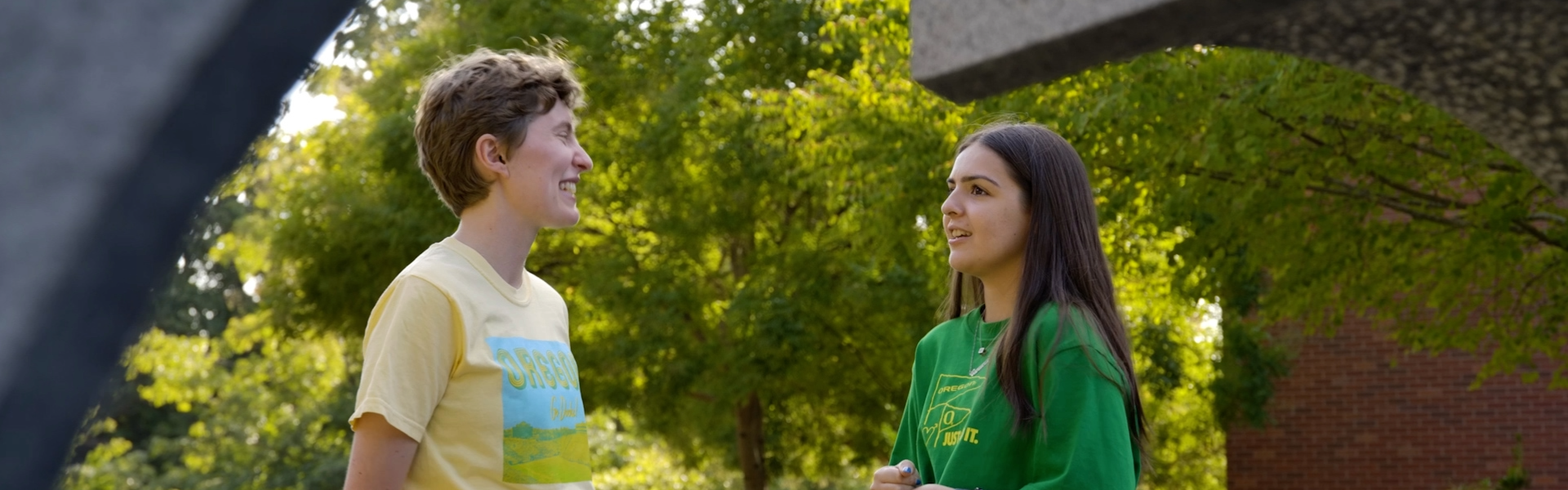 Two students standing and talking