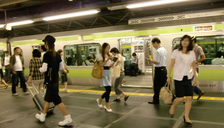 Tokyo-in-Transit People rush on and off a subway in Japan.