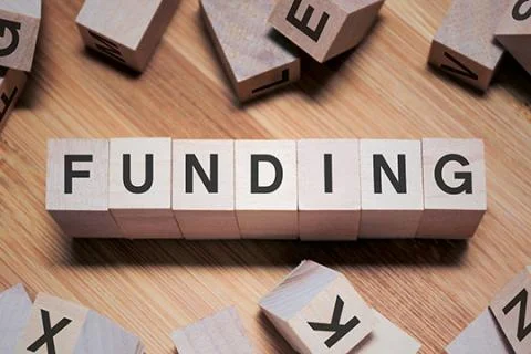 Wooden blocks spelling the word "funding".