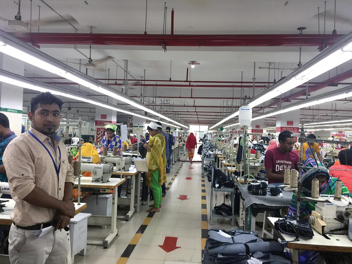 Workers at a compliant factory that has met all safety checks after the 2013 industrial accident. Line supervisor is on the far left. 
