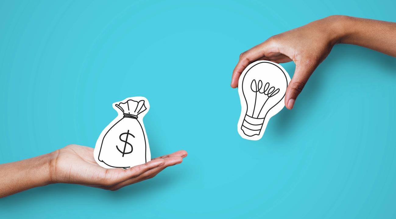 Two hands holding drawings of a lightbulb and a money sack.