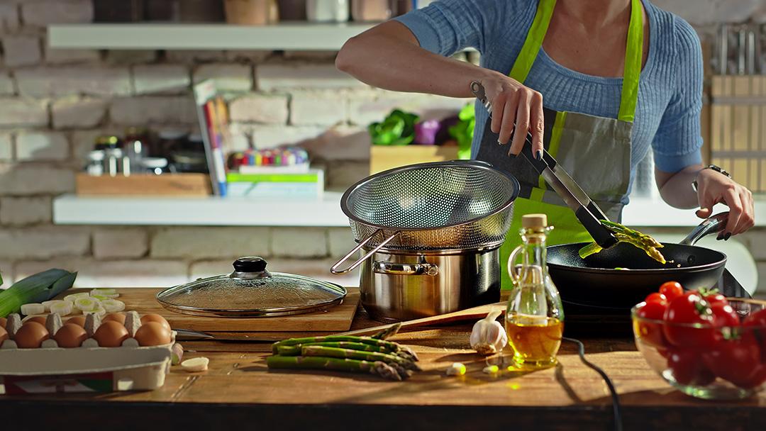 Woman cooking in a kitchen.