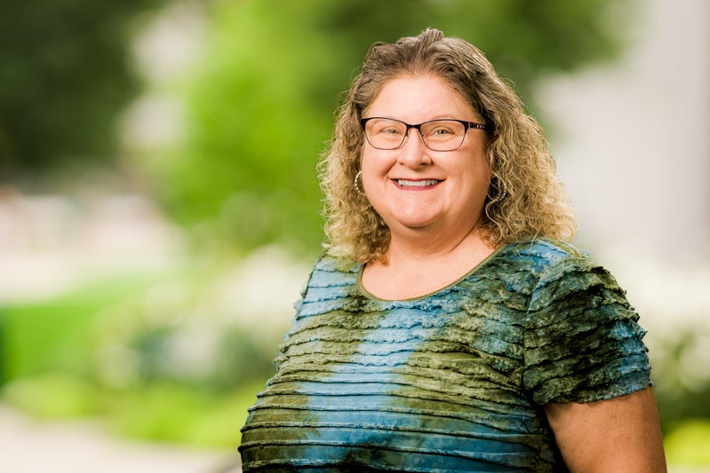 Karyn Schultz wearing a green and blue blouse