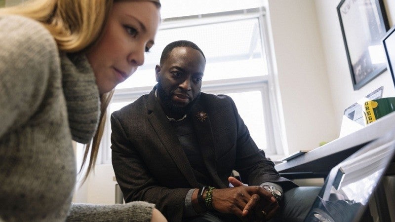 SOJC professor Troy Elias (right) and graduate student Dani Clarke are giving an international scope to research on how people view climate change.