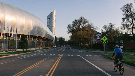 A cyclist passes Hayward Field on the University of Oregon campus in Eugene