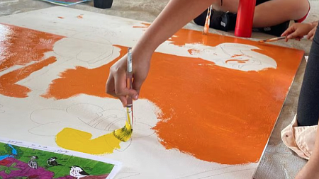 A student makes art as they connect with peers over shared migratory birds