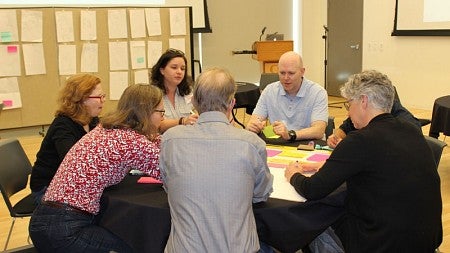 UO faculty members work together at a May 2019 symposium kicking off the Resilience Initiative, which supports interdisciplinary research addressing social and environmental challenges. Seven teams recently received seed funding grants.
