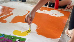 A student makes art as they connect with peers over shared migratory birds