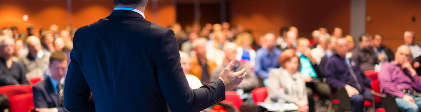 Man giving a speech at a conference