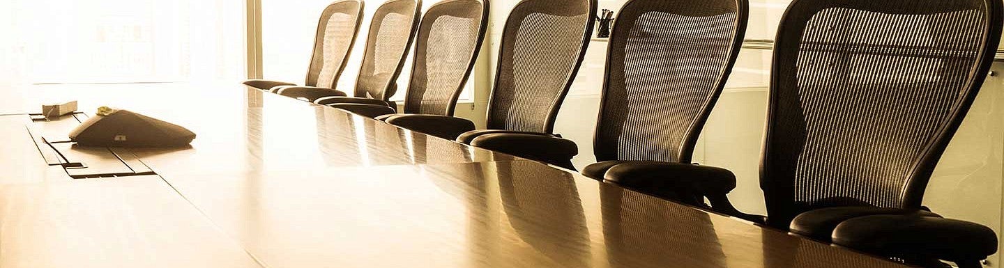 Empty board room table with chairs