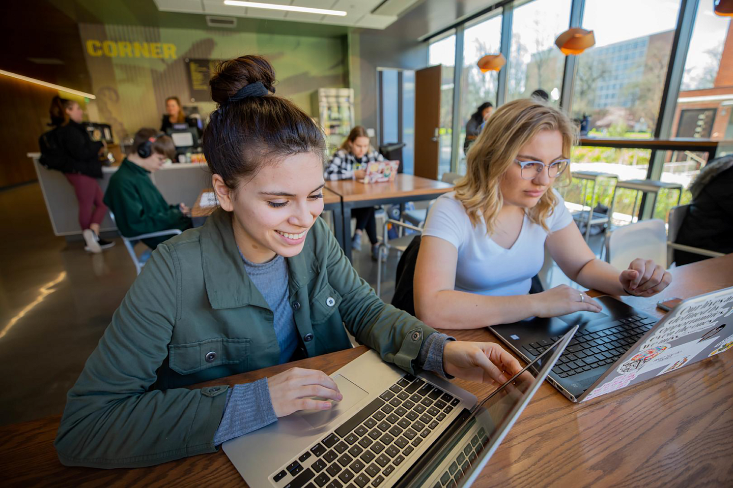 students on laptops in a cafe