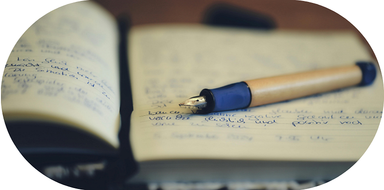 Calligraphy pen resting on a notebook