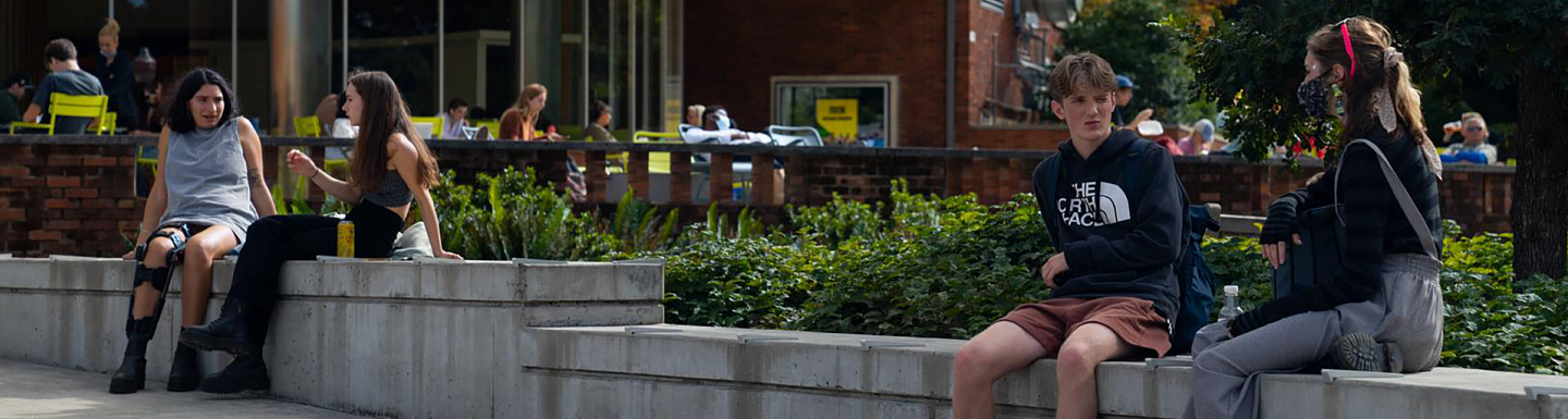 students sitting down outside of the E M U amphitheater