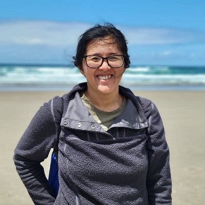women with glasses standing on a beach