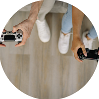 Two sets of hands holding gaming controllers
