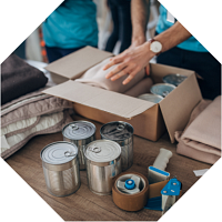 Person packing cans into a box