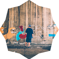 Man standing in front of graffiti