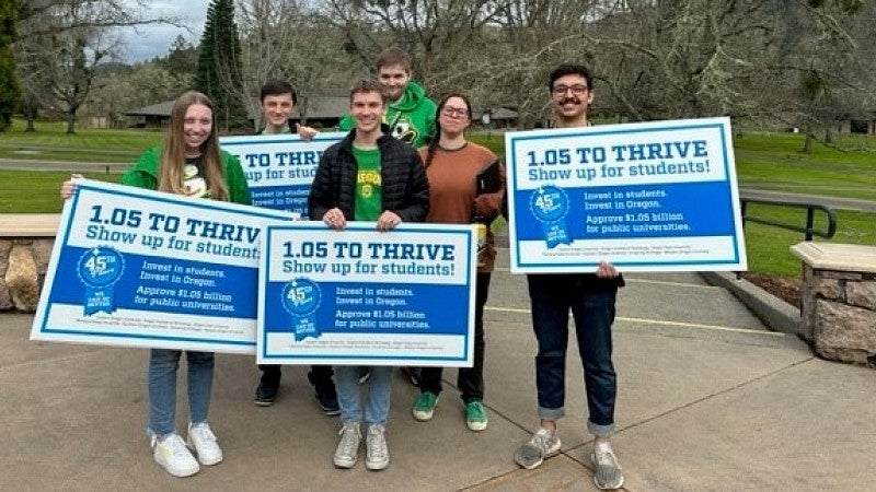 Students hold signs and advocate for the Public University Support Fund
