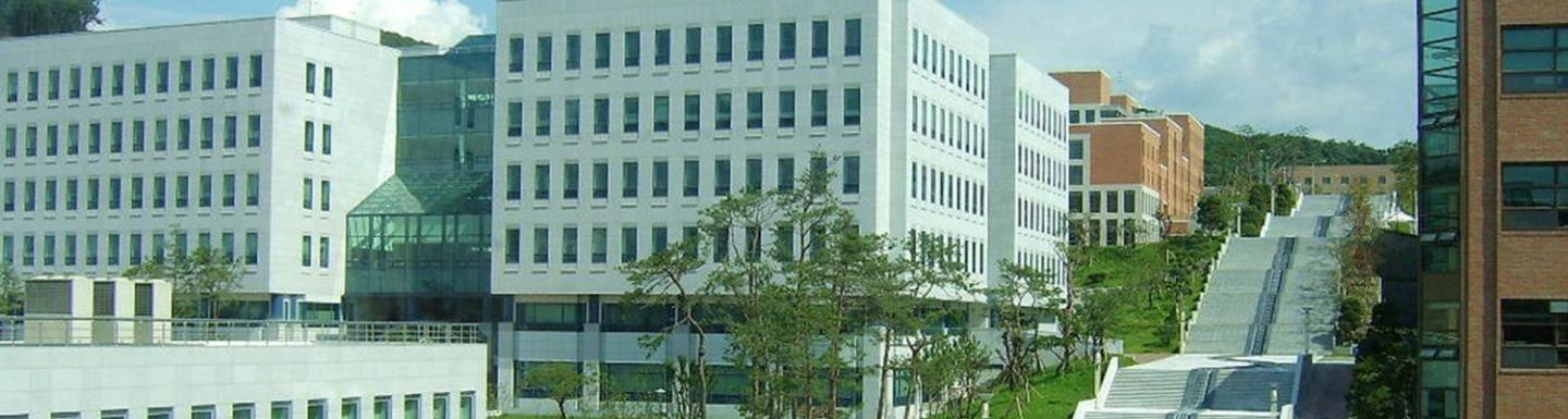 Street view of Dankook University buildings under a blue sky. 