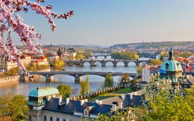 Historic buildings on the shore of a river, two bridges spanning river visible