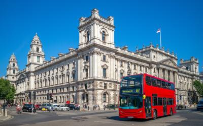 Street view of London with red double decker bus.