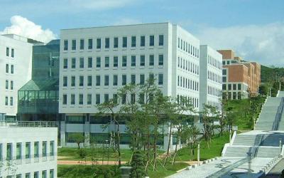Street view of Dankook University buildings under a blue sky. 